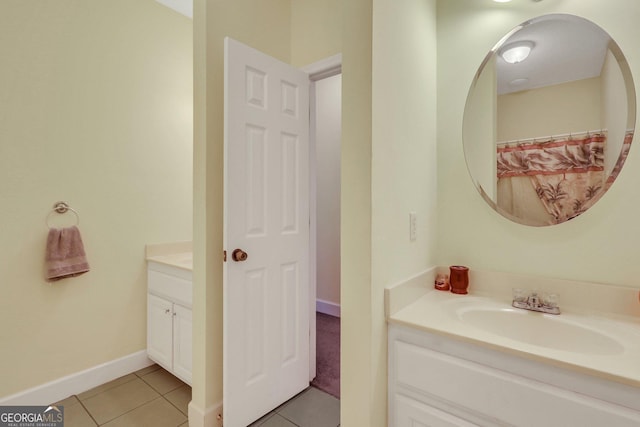full bathroom with tile patterned flooring, vanity, and baseboards
