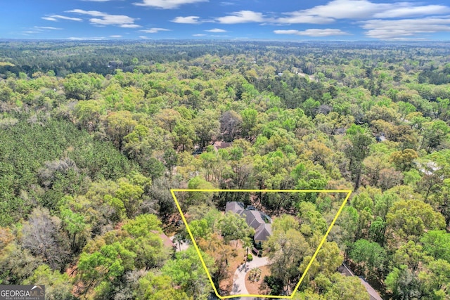 birds eye view of property featuring a view of trees