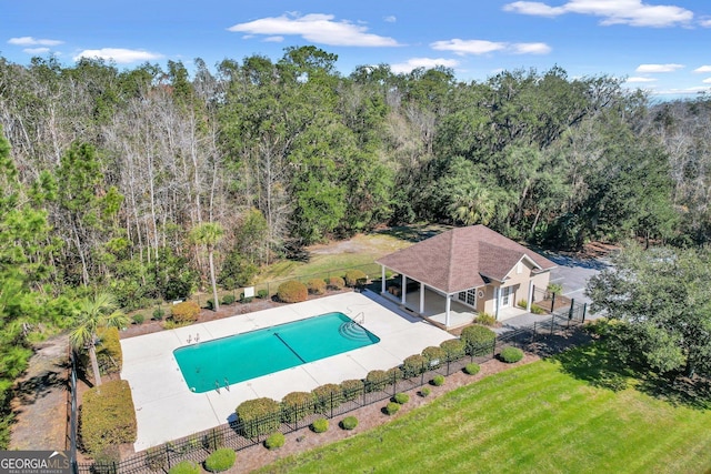 view of swimming pool with a lawn, a fenced in pool, fence, and a patio