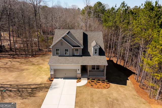 321 Principal Meridian Dr, Dallas, GA 30132 - traditional home with covered porch, a shingled roof, concrete driveway, and an attached garage