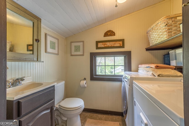 207 County Road 561, Woodland, AL 36280 - bathroom with vanity, lofted ceiling, toilet, wood ceiling, and washing machine and dryer