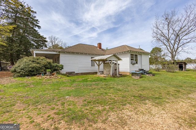 207 County Road 561, Woodland, AL 36280 - back of house featuring a lawn, a chimney, and a shingled roof