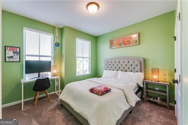 bedroom with baseboards and carpet