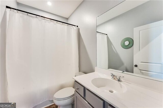 full bath featuring toilet and vanity