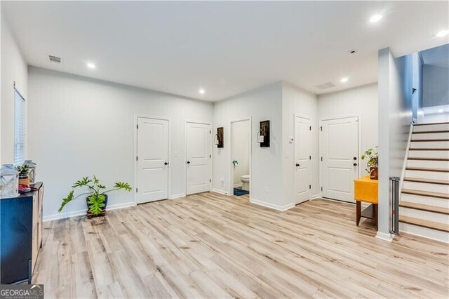 interior space featuring visible vents, recessed lighting, light wood-style floors, and stairway
