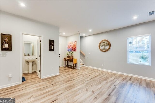 empty room with recessed lighting, visible vents, stairs, and light wood-type flooring