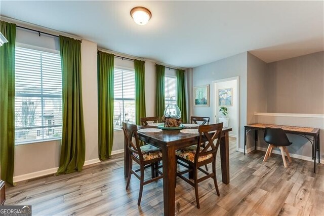 dining room featuring baseboards and light wood-style floors