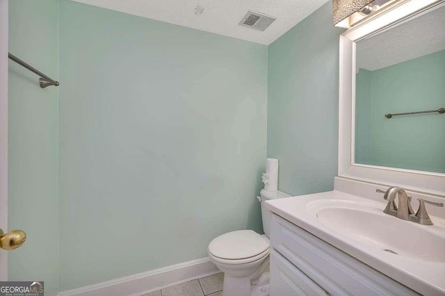 809 Mallery St Unit A, Saint Simons, GA 31522 - bathroom with vanity, tile patterned flooring, and a textured ceiling