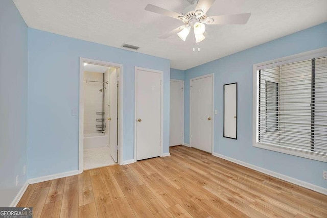 809 Mallery St Unit A, Saint Simons, GA 31522 - unfurnished bedroom featuring light wood-type flooring, ensuite bath, and ceiling fan