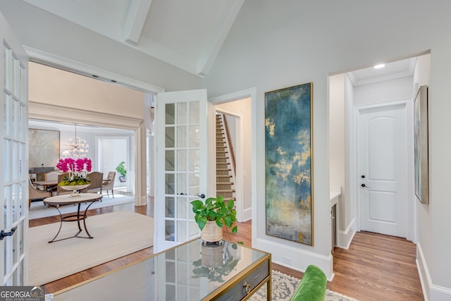 interior space featuring baseboards, wood finished floors, french doors, and a chandelier