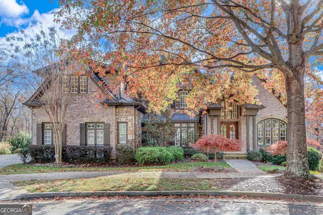 view of front facade featuring french doors and brick siding