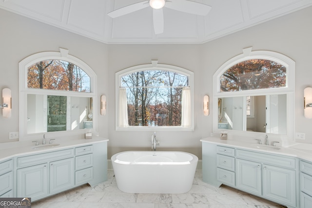 bathroom featuring marble finish floor, a wealth of natural light, and a sink