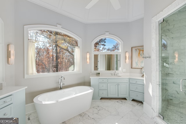 full bathroom featuring a stall shower, vanity, a ceiling fan, a soaking tub, and marble finish floor