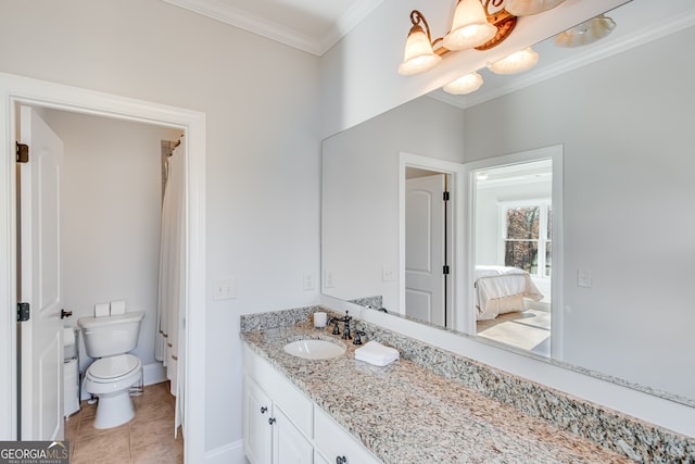ensuite bathroom with ensuite bathroom, crown molding, toilet, vanity, and tile patterned flooring