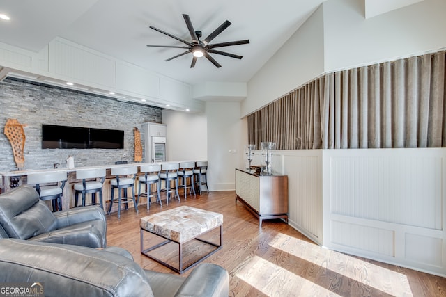 living room featuring baseboards, wood finished floors, recessed lighting, and a ceiling fan