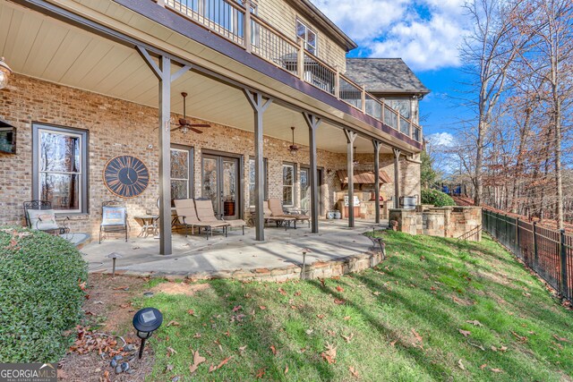 exterior space featuring a balcony, fence, and ceiling fan