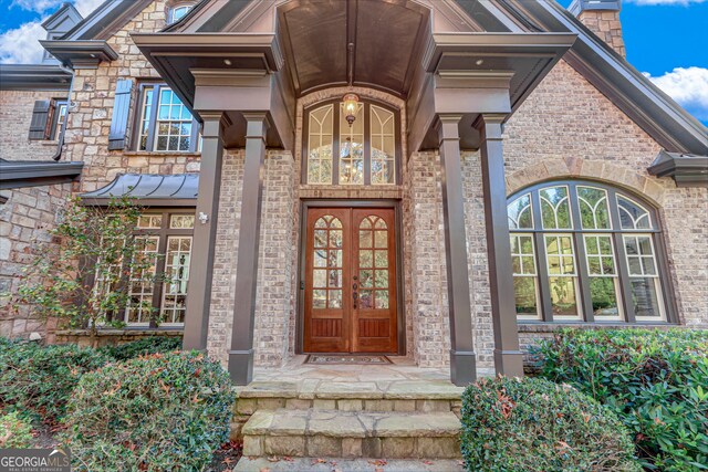 property entrance featuring a chimney and french doors