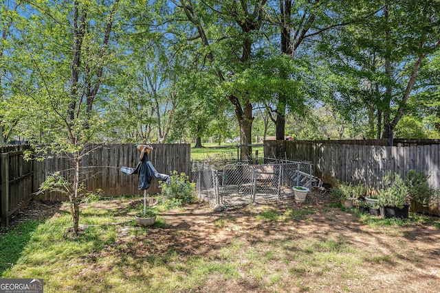 view of yard featuring a fenced backyard and a gate