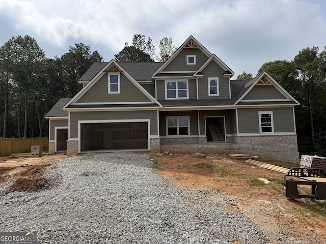 1081 Holly Dr, Loganville, GA 30052 - craftsman-style home with driveway, roof with shingles, fence, and brick siding