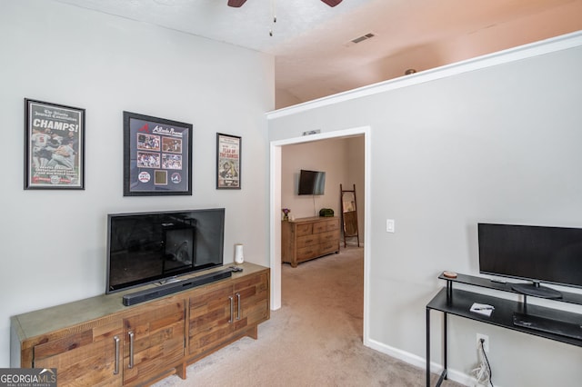 interior space with visible vents, vaulted ceiling, carpet flooring, and ceiling fan