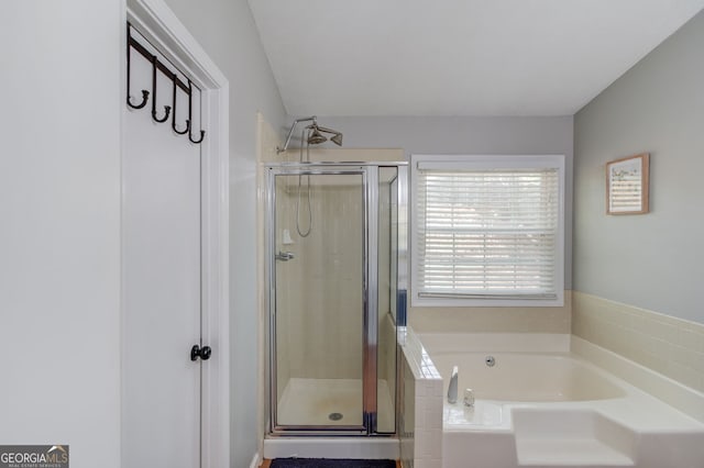 bathroom with a bath and a stall shower