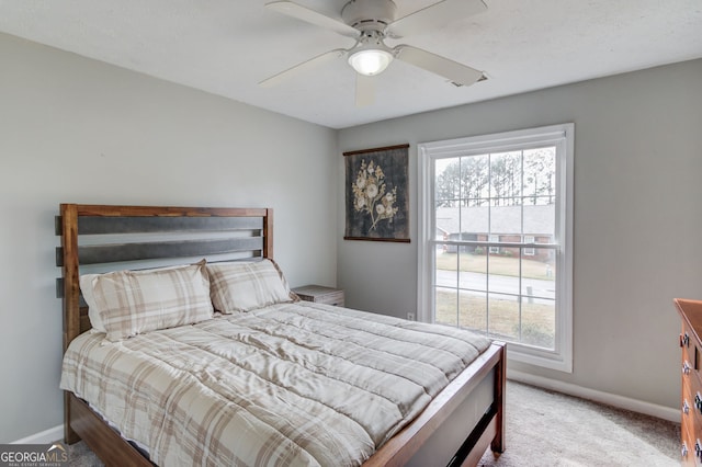 bedroom with baseboards, a ceiling fan, and carpet
