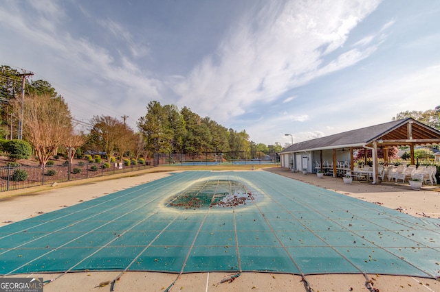 view of pool featuring a gazebo, a tennis court, and fence
