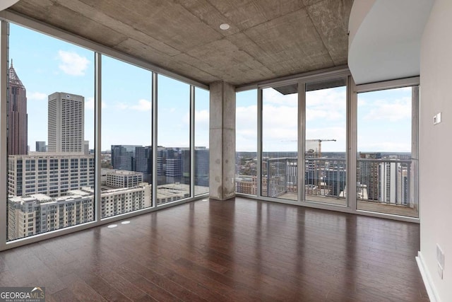 855 Peachtree St NE Unit 2403, Atlanta, GA 30308 - spare room featuring expansive windows, hardwood / wood-style flooring, and a view of city