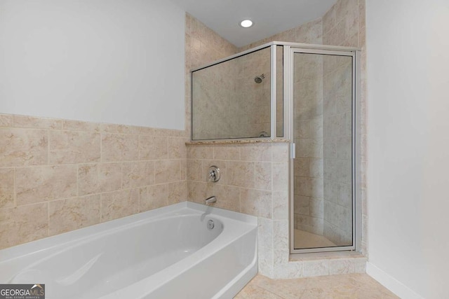 855 Peachtree St NE Unit 2403, Atlanta, GA 30308 - bathroom featuring a stall shower, a garden tub, and tile patterned flooring