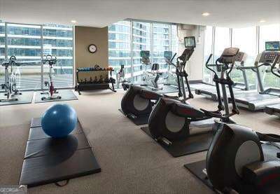 855 Peachtree St NE Unit 2403, Atlanta, GA 30308 - gym featuring a wall of windows and carpet flooring