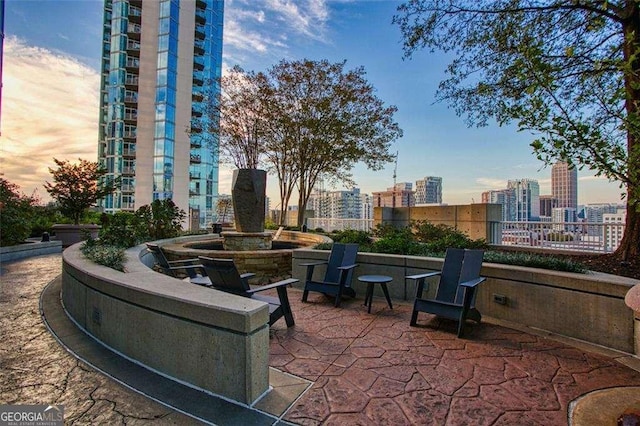 855 Peachtree St NE Unit 2403, Atlanta, GA 30308 - patio terrace at dusk featuring a view of city and a patio