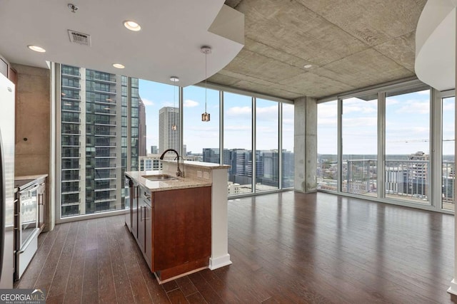 855 Peachtree St NE Unit 2403, Atlanta, GA 30308 - kitchen with floor to ceiling windows, a city view, white electric range, dark wood finished floors, and plenty of natural light