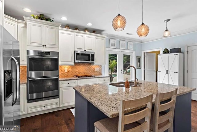 108 Summer Breeze Ln, Canton, GA 30114 - kitchen with appliances with stainless steel finishes, a sink, decorative backsplash, dark wood-type flooring, and white cabinets