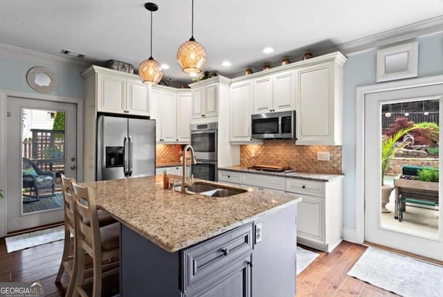 108 Summer Breeze Ln, Canton, GA 30114 - kitchen featuring appliances with stainless steel finishes, ornamental molding, a sink, light stone countertops, and decorative backsplash
