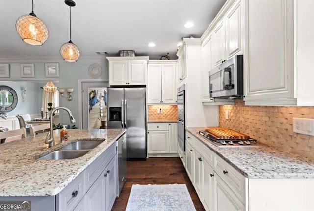 108 Summer Breeze Ln, Canton, GA 30114 - kitchen with appliances with stainless steel finishes, a sink, a center island with sink, dark wood finished floors, and hanging light fixtures