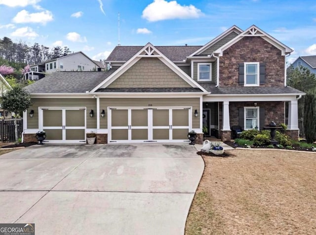 108 Summer Breeze Ln, Canton, GA 30114 - craftsman-style house with stone siding, driveway, a garage, and roof with shingles