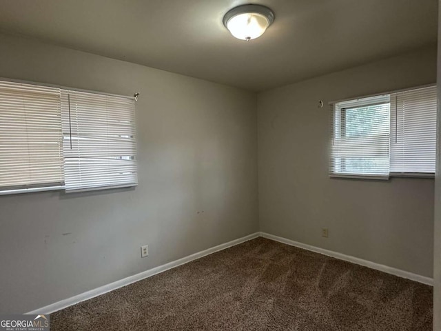 3025 Mckenzie Rd, Atlanta, GA 30344 - empty room with dark colored carpet and baseboards