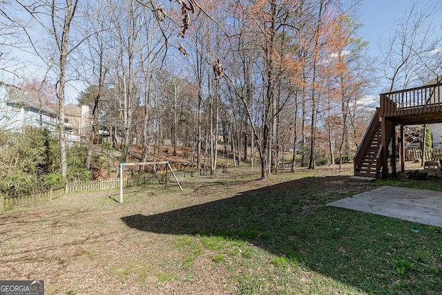 2032 Stonewick Ct, Lawrenceville, GA 30043 - view of yard featuring stairs, a playground, a wooden deck, and a patio