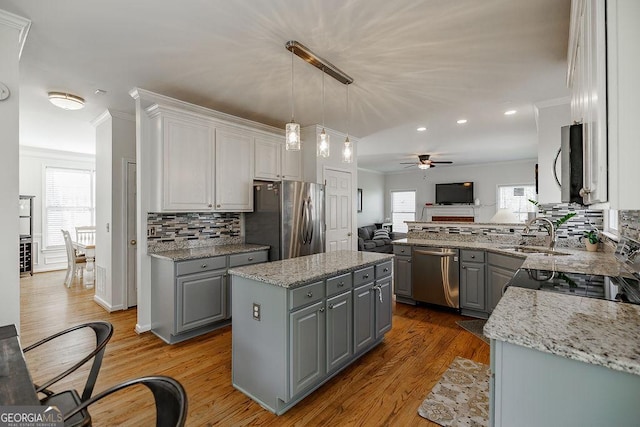 2032 Stonewick Ct, Lawrenceville, GA 30043 - kitchen featuring gray cabinetry, stainless steel appliances, ceiling fan, open floor plan, and backsplash