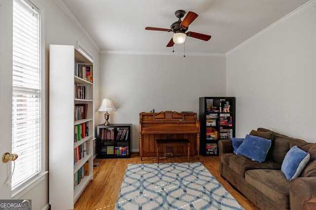 2032 Stonewick Ct, Lawrenceville, GA 30043 - living room featuring a ceiling fan, ornamental molding, and light wood finished floors