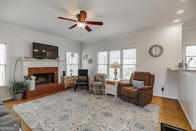 2032 Stonewick Ct, Lawrenceville, GA 30043 - living area with a ceiling fan, wood finished floors, ornamental molding, a brick fireplace, and recessed lighting