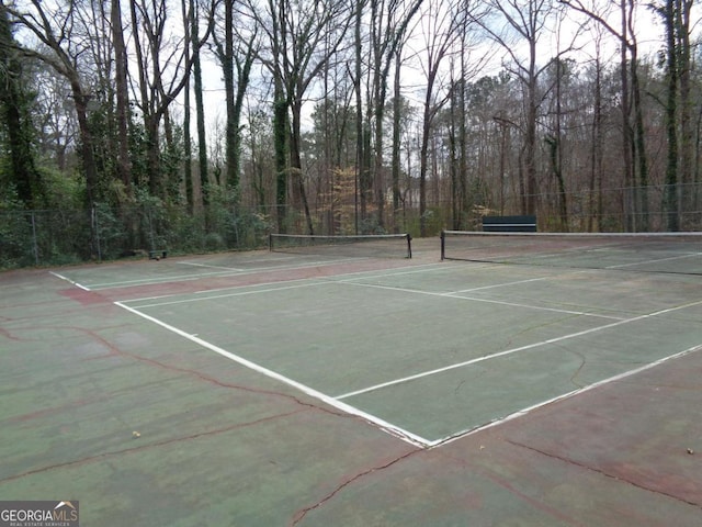 view of sport court with fence