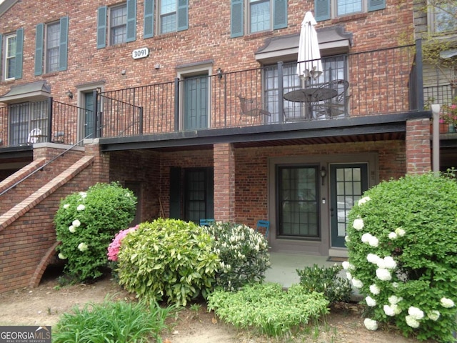 view of exterior entry featuring brick siding