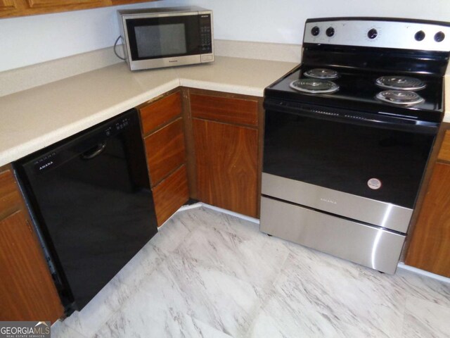 kitchen with light countertops, marble finish floor, appliances with stainless steel finishes, and brown cabinets