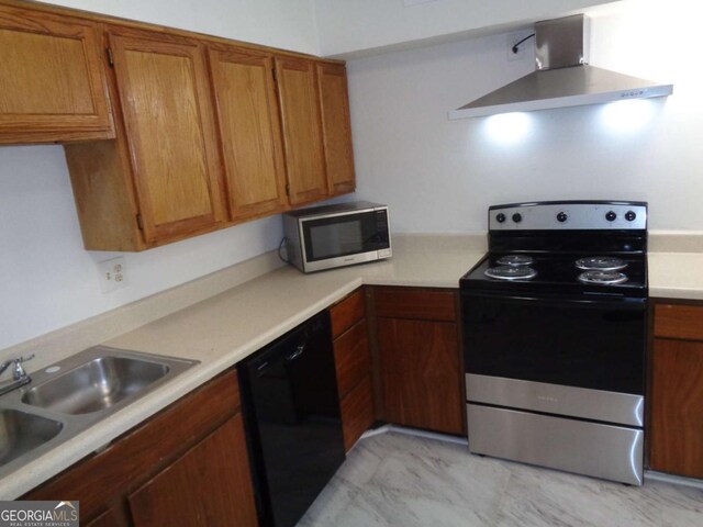 kitchen with light countertops, a sink, appliances with stainless steel finishes, brown cabinetry, and under cabinet range hood