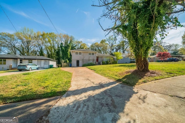 split level home with concrete driveway and a front yard