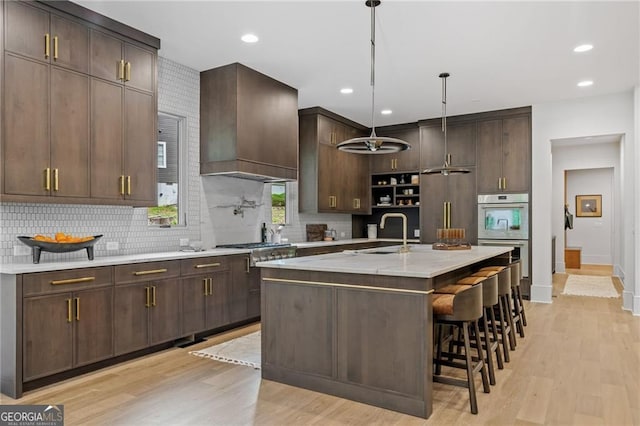402 Chattahoochee St, Roswell, GA 30075 - kitchen with premium range hood, light countertops, light wood-style floors, backsplash, and recessed lighting