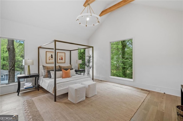 402 Chattahoochee St, Roswell, GA 30075 - bedroom with high vaulted ceiling, beamed ceiling, a chandelier, and wood finished floors