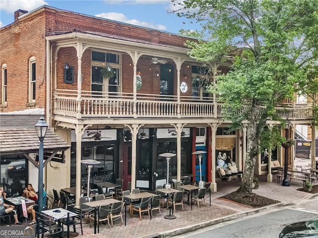 402 Chattahoochee St, Roswell, GA 30075 - rear view of property featuring a balcony, ceiling fan, brick siding, and a chimney