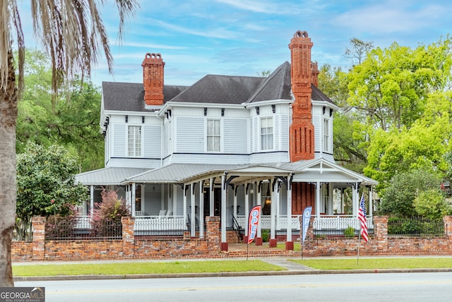 622 Main St, Blackshear, GA 31516 - view of front facade featuring a chimney, a shingled roof, and a porch